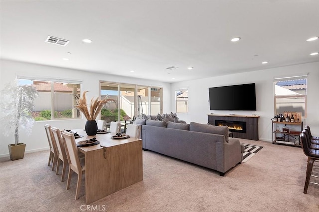 11475 Sheridan Way, Beaumont, CA 92223 - living area with light carpet, recessed lighting, a tiled fireplace, and baseboards