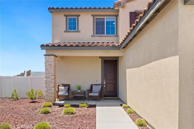 11475 Sheridan Way, Beaumont, CA 92223 - view of exterior entry featuring fence, stucco siding, and a tiled roof