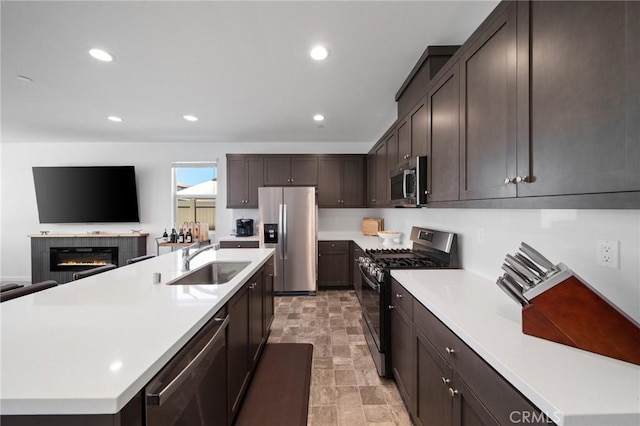 11475 Sheridan Way, Beaumont, CA 92223 - kitchen with stainless steel appliances, a sink, light countertops, an island with sink, and recessed lighting