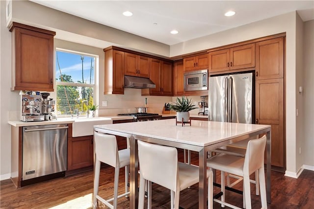 1508 W Artesia Unit H, Gardena, CA 90248 - kitchen featuring stainless steel appliances, a sink, under cabinet range hood, dark wood-type flooring, and light countertops