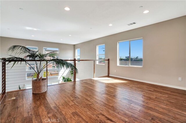 1508 W Artesia Unit H, Gardena, CA 90248 - spare room featuring wood finished floors, baseboards, plenty of natural light, and recessed lighting