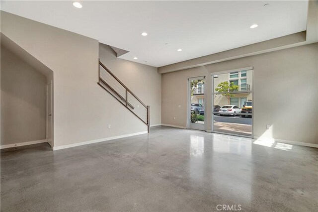 1508 W Artesia Unit H, Gardena, CA 90248 - unfurnished living room featuring finished concrete floors, recessed lighting, baseboards, and stairway