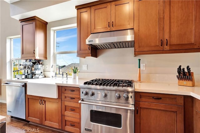 1508 W Artesia Unit H, Gardena, CA 90248 - kitchen with stainless steel appliances, under cabinet range hood, a sink, light countertops, and brown cabinets