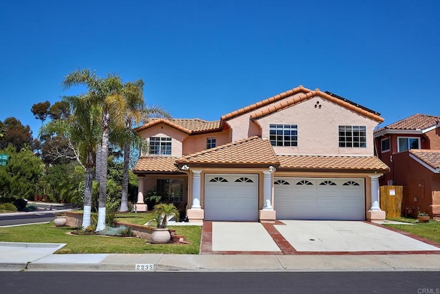 2935 Via Emerado, Carlsbad, CA 92009 - mediterranean / spanish-style house featuring a tiled roof, stucco siding, concrete driveway, and an attached garage