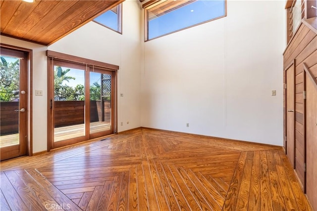 spare room with healthy amount of natural light and a high ceiling