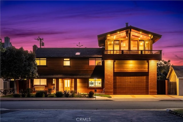 2405 Tustin Ave, Costa Mesa, CA 92627 - view of front of home featuring a balcony, an attached garage, concrete driveway, and fence