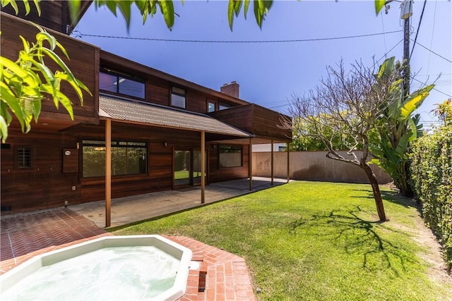 view of yard with an outdoor hot tub and a patio