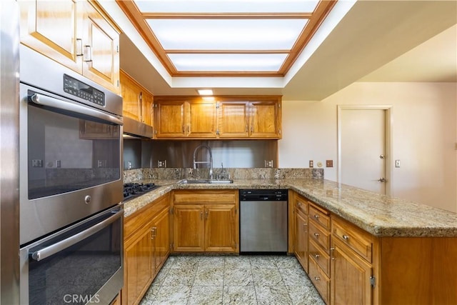 2405 Tustin Ave, Costa Mesa, CA 92627 - kitchen with stainless steel appliances, a sink, a peninsula, and brown cabinets