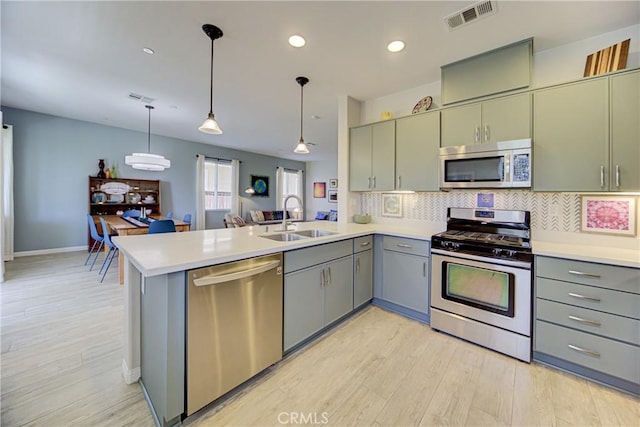 43075 Beamer Ct, Temecula, CA 92592 - kitchen featuring appliances with stainless steel finishes, a sink, gray cabinets, a peninsula, and recessed lighting