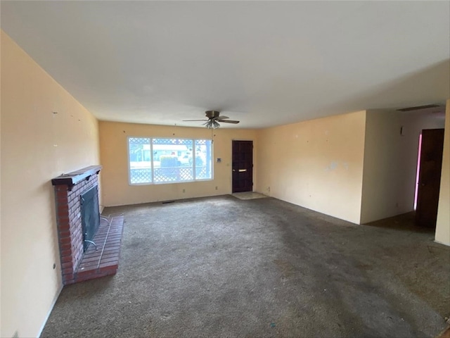 unfurnished living room with carpet floors, a brick fireplace, and a ceiling fan