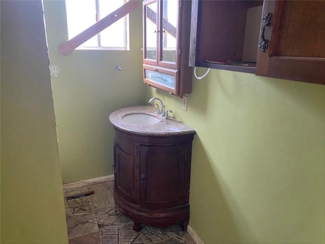 bathroom featuring vanity and baseboards