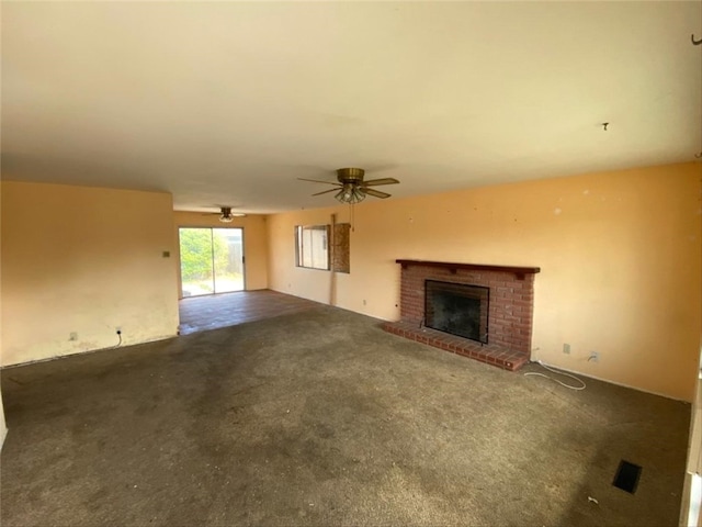 unfurnished living room featuring a fireplace, carpet flooring, and ceiling fan