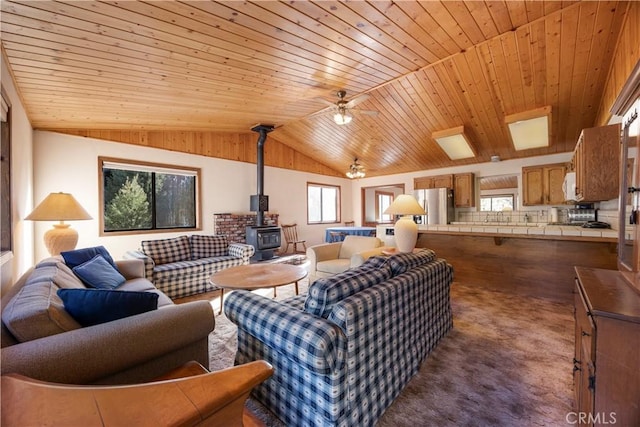 2513 Arbor Dr, Pine Mountain Club, CA 93225 - carpeted living room with a wood stove, wood ceiling, healthy amount of natural light, vaulted ceiling, and a ceiling fan