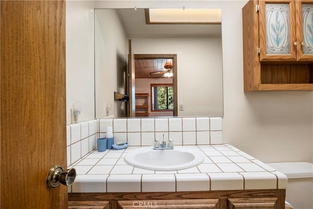 2513 Arbor Dr, Pine Mountain Club, CA 93225 - half bathroom with vanity, tasteful backsplash, and toilet