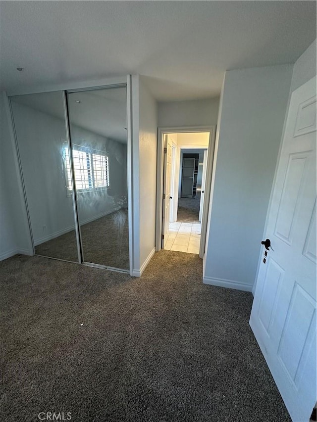 22564 Inspiration Pt, Canyon Lake, CA 92587 - unfurnished bedroom featuring carpet floors, baseboards, and a closet