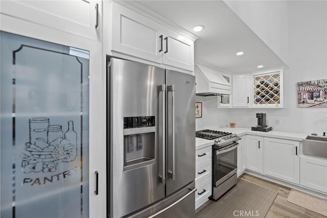 2514 N Tustin Ave Unit 71, Santa Ana, CA 92705 - kitchen featuring stainless steel appliances, light countertops, white cabinetry, and recessed lighting