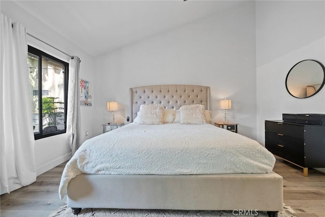 2514 N Tustin Ave Unit 71, Santa Ana, CA 92705 - bedroom featuring light wood-style floors, vaulted ceiling, and baseboards