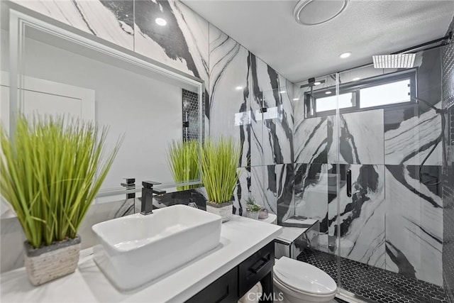 2514 N Tustin Ave Unit 71, Santa Ana, CA 92705 - bathroom featuring toilet, a marble finish shower, vanity, tile walls, and a textured ceiling
