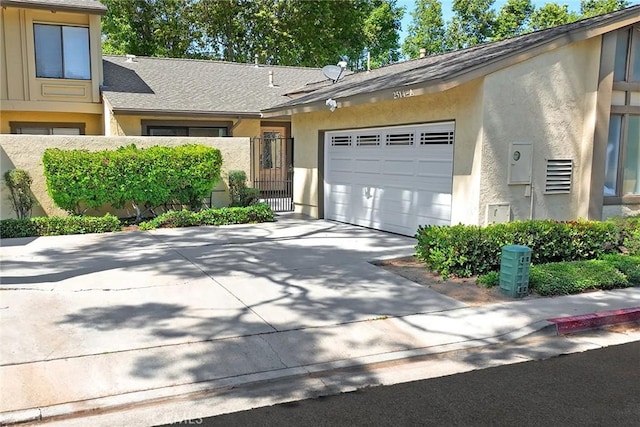 2514 N Tustin Ave Unit 71, Santa Ana, CA 92705 - view of property with an attached garage, stucco siding, and concrete driveway