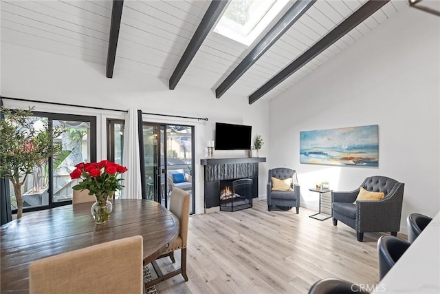 2514 N Tustin Ave Unit 71, Santa Ana, CA 92705 - dining space with wood finished floors, a lit fireplace, wood ceiling, and baseboards