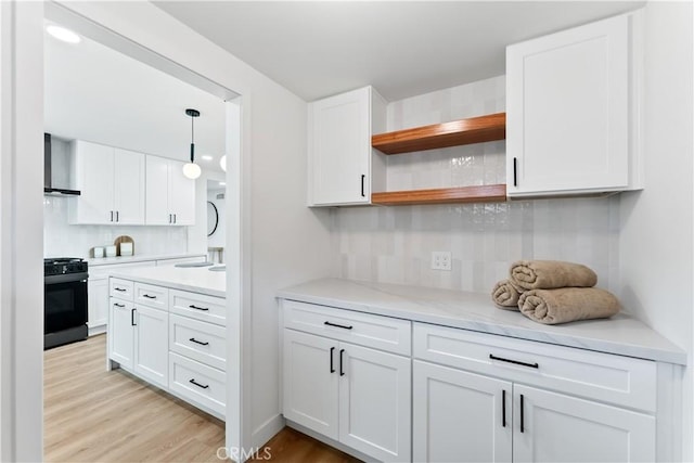 2514 S Rita Way, Santa Ana, CA 92704 - kitchen featuring gas stove, wall chimney range hood, decorative backsplash, open shelves, and white cabinets