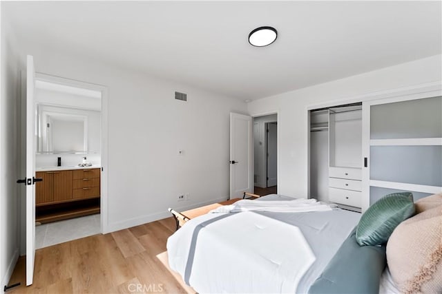 2514 S Rita Way, Santa Ana, CA 92704 - bedroom featuring light wood-style flooring, a closet, ensuite bath, and baseboards