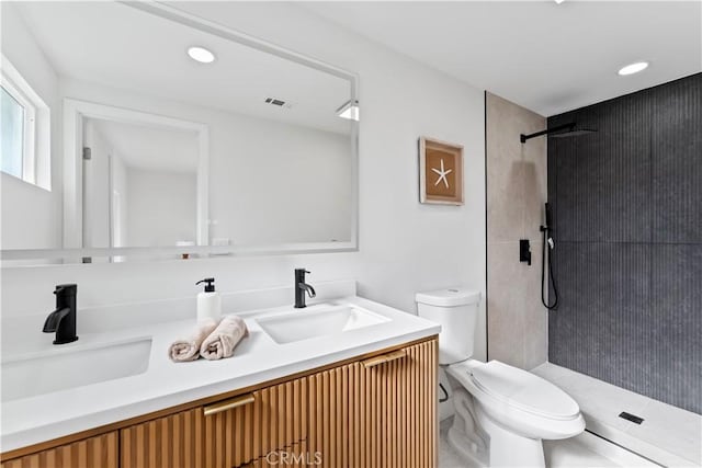 2514 S Rita Way, Santa Ana, CA 92704 - bathroom featuring toilet, tiled shower, double vanity, and recessed lighting
