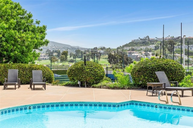2005 Costa Del Mar Rd Unit 632, Carlsbad, CA 92009 - view of pool with fence, a mountain view, and a patio