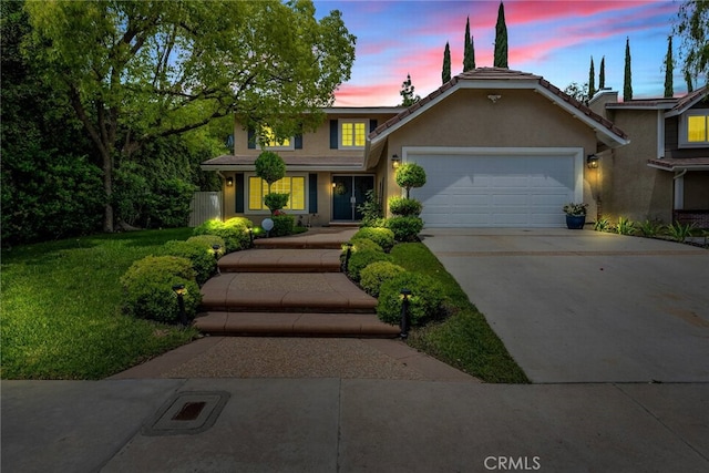 24441 Indian Hill Ln, West Hills, CA 91307 - traditional home with a garage, driveway, stucco siding, and a lawn