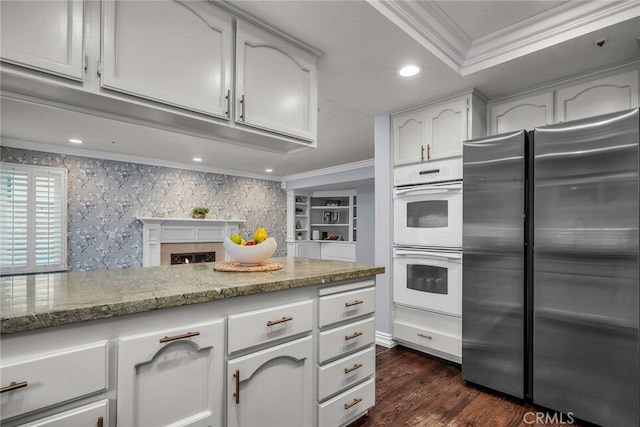 24441 Indian Hill Ln, West Hills, CA 91307 - kitchen featuring freestanding refrigerator, double oven, crown molding, light stone counters, and dark wood finished floors
