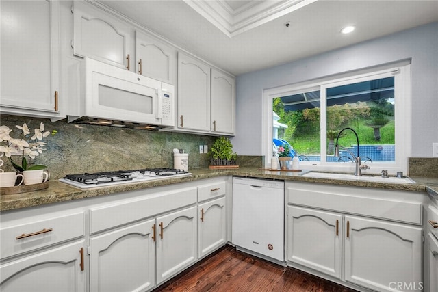 24441 Indian Hill Ln, West Hills, CA 91307 - kitchen with white appliances, dark wood-style flooring, decorative backsplash, white cabinets, and recessed lighting