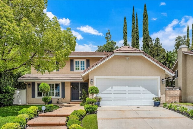 24441 Indian Hill Ln, West Hills, CA 91307 - traditional-style house with an attached garage, driveway, stucco siding, and a tile roof