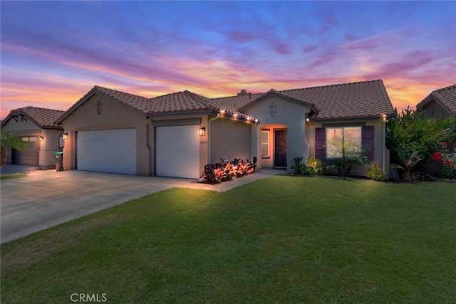 25515 Mountain Springs St, Menifee, CA 92584 - mediterranean / spanish home featuring a garage, a tile roof, a front yard, driveway, and stucco siding