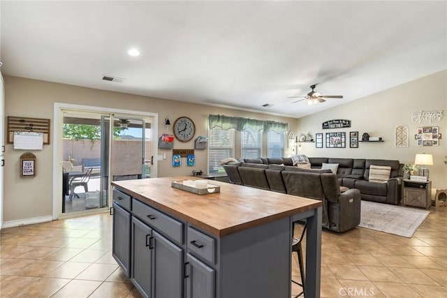 25515 Mountain Springs St, Menifee, CA 92584 - kitchen featuring wood counters, ceiling fan, light tile patterned floors, gray cabinets, and a center island