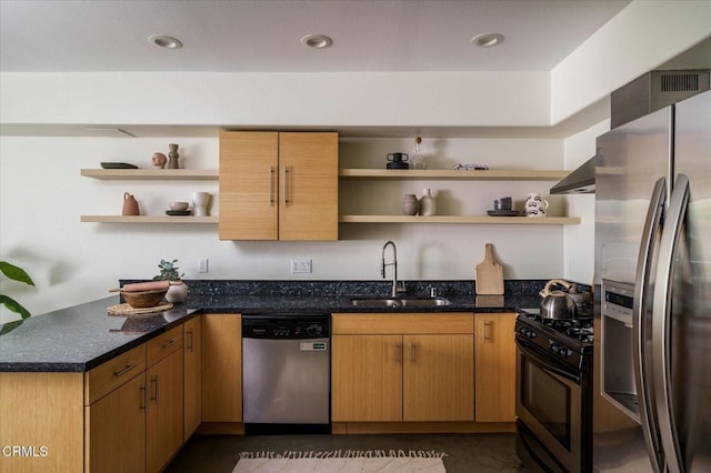 kitchen featuring open shelves, stainless steel appliances, a sink, dark stone counters, and a peninsula