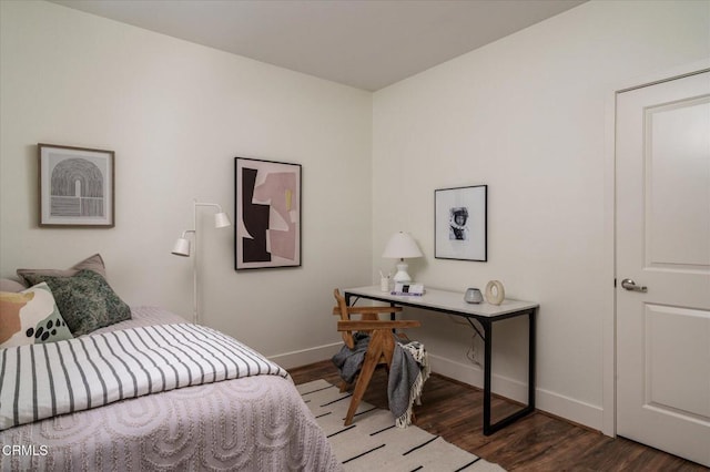 bedroom featuring baseboards and wood finished floors