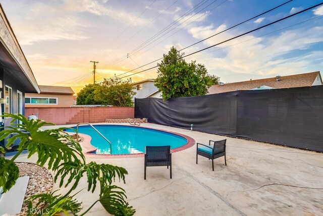 view of pool featuring a fenced backyard and a patio