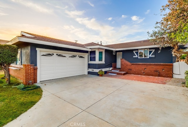 single story home with an attached garage, driveway, brick siding, crawl space, and stucco siding
