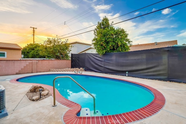 view of pool with a fenced backyard