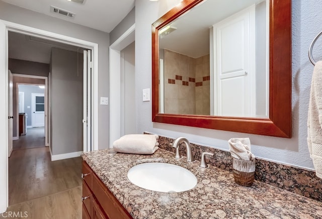 bathroom featuring vanity and wood finished floors