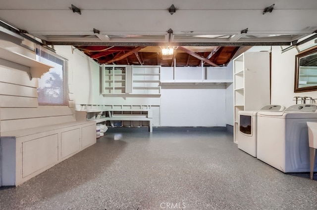 basement featuring washer and clothes dryer and a garage