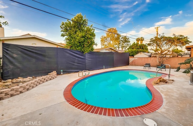 view of swimming pool with a fenced backyard and a patio