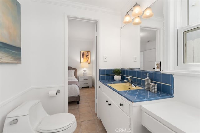 1710 Plaza Del Norte, Newport Beach, CA 92661 - ensuite bathroom with ornamental molding, vanity, tile patterned flooring, and backsplash