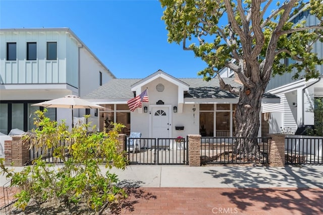1710 Plaza Del Norte, Newport Beach, CA 92661 - view of front of property with a fenced front yard, a shingled roof, stucco siding, and board and batten siding