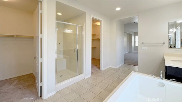 14247 Symphony Ct, Eastvale, CA 92880 - full bath with a stall shower, a bathtub, tile patterned flooring, recessed lighting, and baseboards