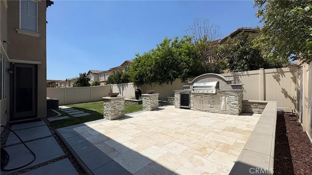 14247 Symphony Ct, Eastvale, CA 92880 - view of patio featuring area for grilling and a fenced backyard
