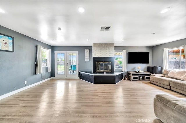 38714 Puerta Ave, Palmdale, CA 93550 - living room with light wood finished floors, recessed lighting, baseboards, and a large fireplace