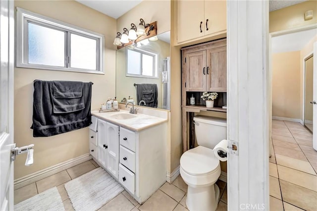 38714 Puerta Ave, Palmdale, CA 93550 - bathroom with toilet, tile patterned flooring, vanity, and baseboards