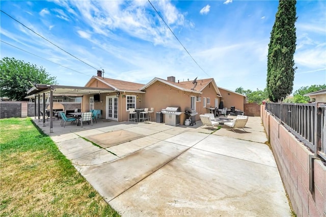 38714 Puerta Ave, Palmdale, CA 93550 - back of property featuring french doors, a fenced backyard, stucco siding, and a patio area