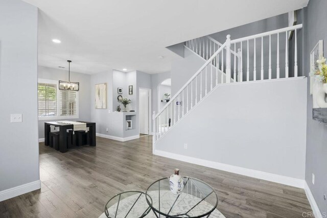 1444 Wooden Valley St, Chula Vista, CA 91913 - unfurnished living room with stairs, wood finished floors, recessed lighting, a chandelier, and arched walkways